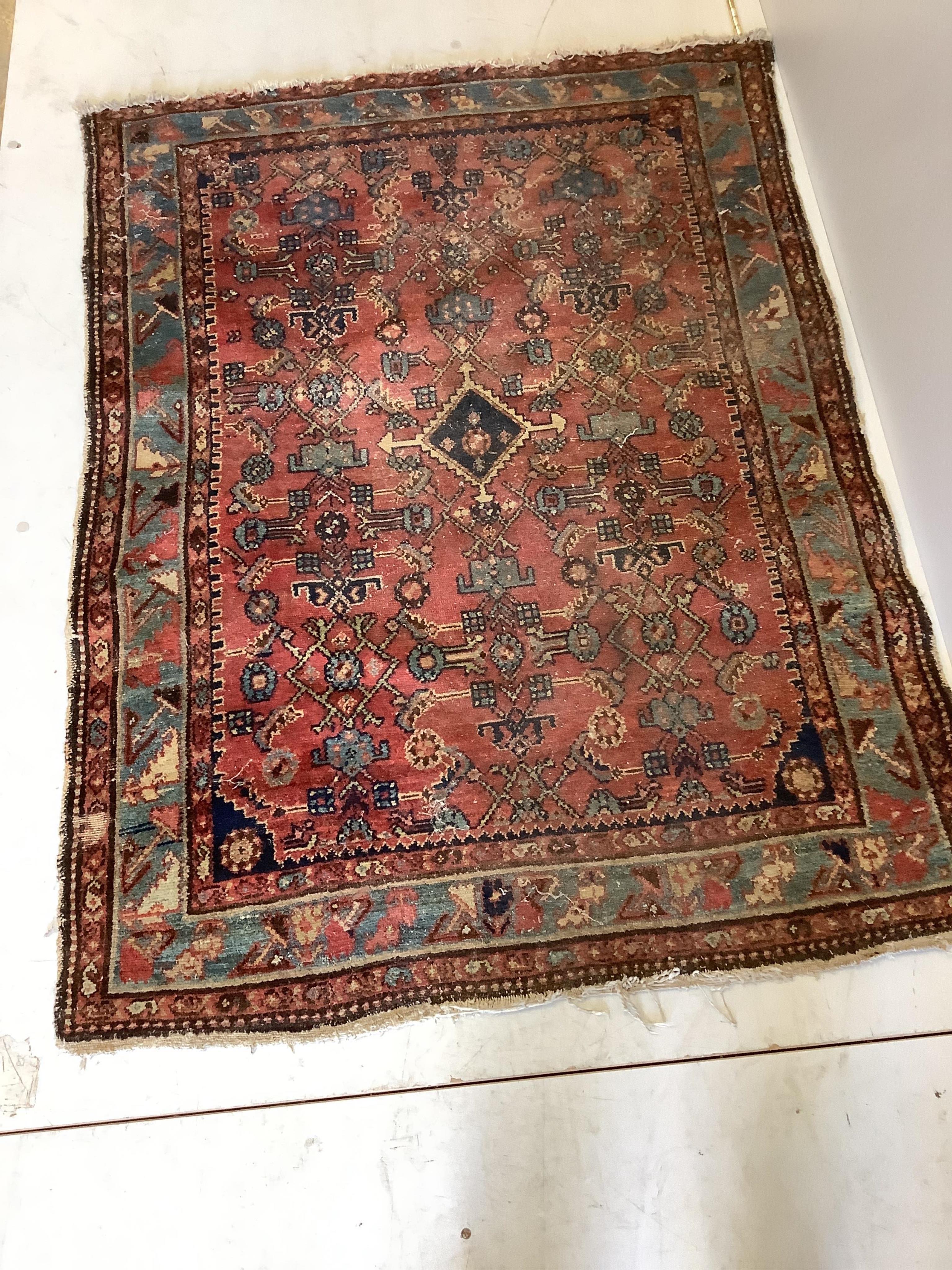 A North West Persian red ground rug, 140 x 104cm. Condition - poor-fair